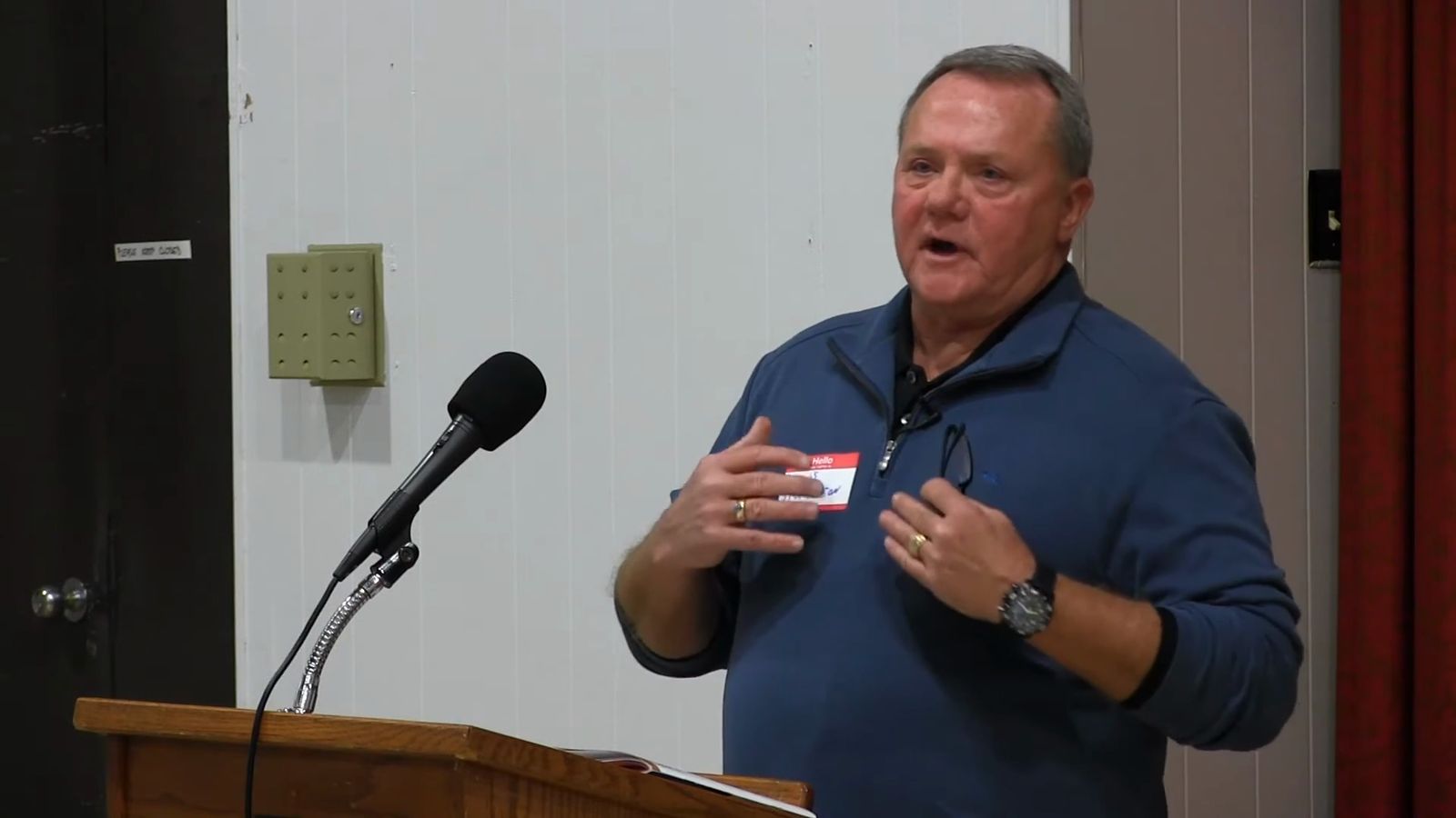 Dennis Stephenson speaking at a podium